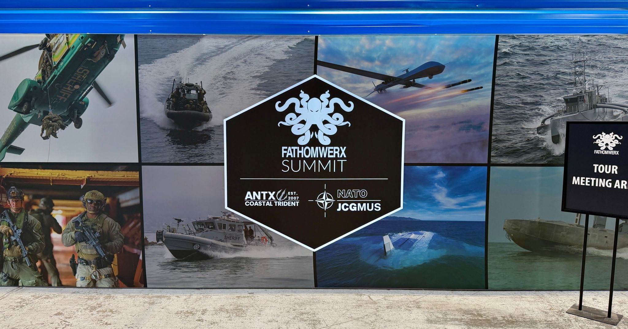 FATHOMWERX Summit signage featuring maritime, air, and unmanned systems imagery at the conference venue.