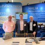LeVanta Tech team members standing at a conference booth in front of HALIA float-and-fly drone display panels.